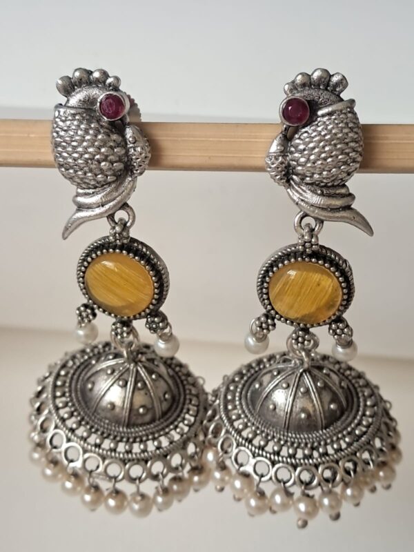 Anvaya Collections Oxidized Brass Peacock Jhumka Earrings with Yellow-Red Stone and Pearl Drops – Ethnic Indian Jewelry